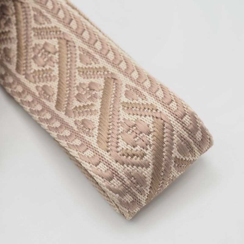 Veskestropp med geometrisk mønster krem beige